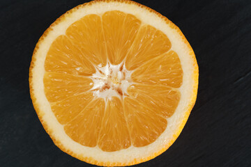 cut of an orange close-up on a black background.