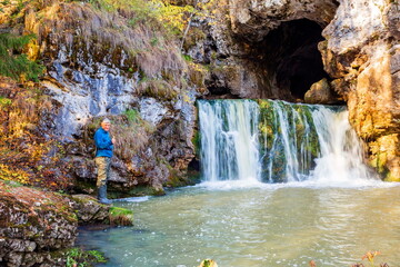 the famous waterfall atysh flowing from a karst funnel in the Ural mountains of Bashkortostan on an...