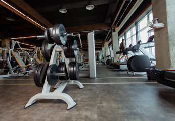 Fototapeta premium Interior of a modern gym. Rack with barbell discs