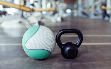 Kettlebell and medicine ball on the gym floor. Fitness, bodybuilding and functional training...