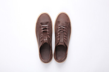 Mens brown leather sneakers on a gray background