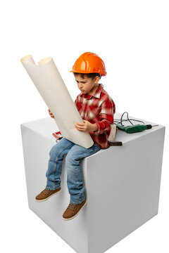  ute little preschool boy, kid in image of builder, architect in orange protective helmet sitting on huge box isolated on white background