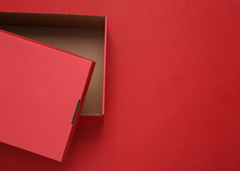 Opened Red cardboard box on a red background. Mock up