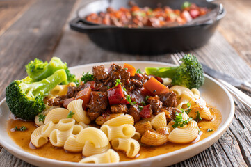 Plate with goulash and pasta. Healthy low fat meal cooked with turkey breast and vegetables
