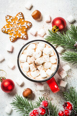 Christmas drink. Hot chocolate with marshmallow and gingerbread cookies with holiday decorations at white table. Top view with copy space.