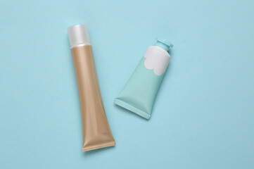 Tube of cream and foundation on a blue background