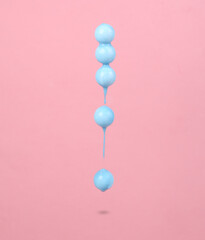 Levitating balls with dripping paint paint on pink background. Minimal creative layout. Concept art.