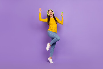 Fototapeta na wymiar Full body photo of youth girl enjoy rhythm radio melody hold cellphone isolated over purple color background