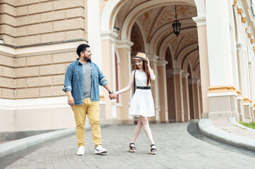 Fototapeta premium Young international couple in love walking in european city