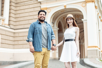 Young international couple in love walking in european city