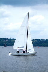 Obraz premium Yacht with white sails on the water, sea and river transport, blue sky, beautiful background. 