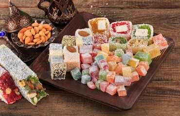 Arabic traditional sweets and berry with tea on plate