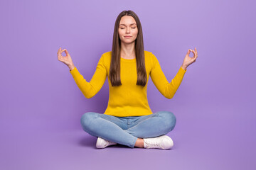 Full body photo of young girl sit floor dream meditate peaceful relax isolated over violet color...