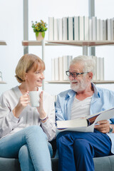 Elderly couple reading a book with smile and romantic emotion.