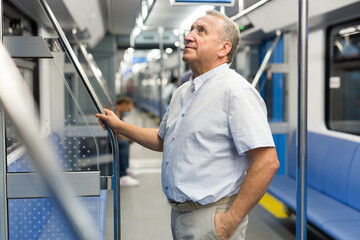 Fototapeta na wymiar Middle aged man in subway car