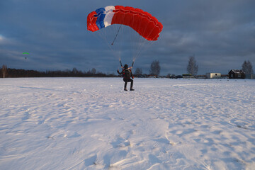 Skydiving. A parachute pilot is landing.