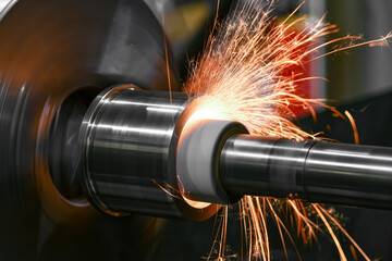 The abrasive wheel removes the excess metal layer, sparks fly to the sides.