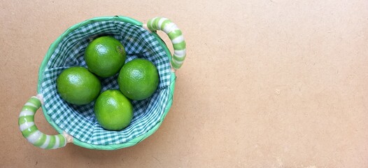 Lemon in a basket. Wooden background.