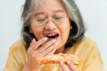 Happy Asian senior women enjoying eating pie