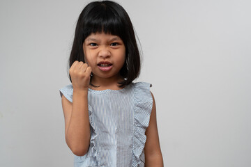 Portrait of Asian angry and sad little girl on white isolated background, The emotion of a child...
