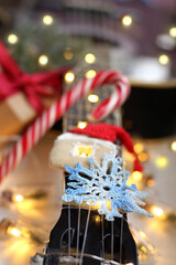 blue knitted snowflake rests on guitar strings in a festive atmosphere. warm music of winter holidays
