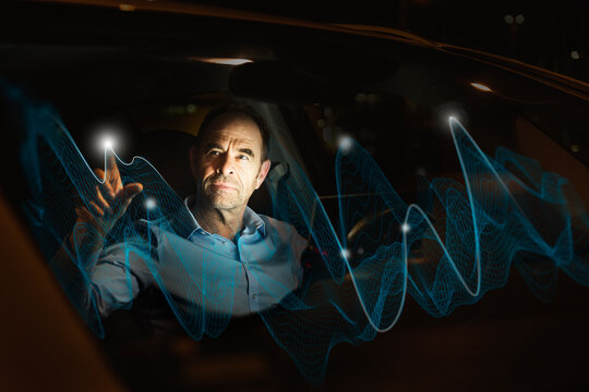 Businessman touching wave graph in car