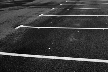 white road markings on black asphalt for parking cars