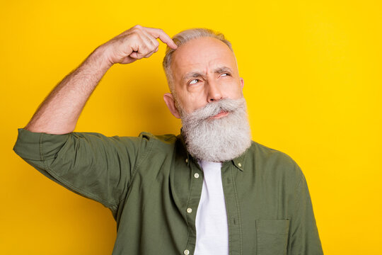 Photo portrait of elder man looking blank space thinking about idea isolated bright yellow color background