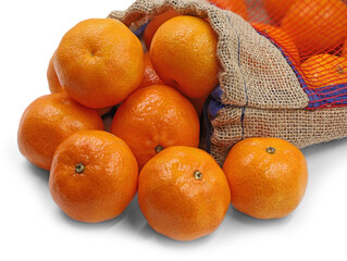 Ripe orange tangerines or mandarins lying in a mesh bag on a white background, close up
