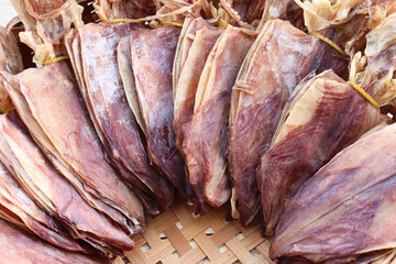 New round dried squid large seafood clean fresh Thai delicious food snacked on wicker basket...