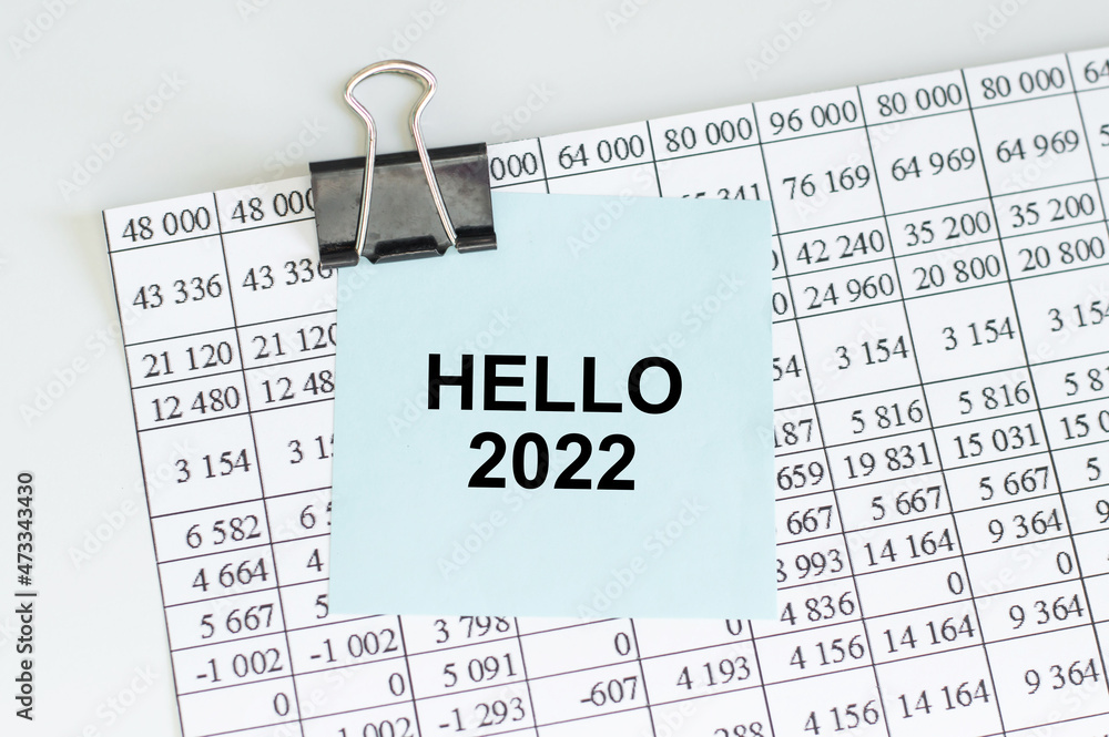 Poster HELLO 2022 text on blue note paper clip to sheet with numbers on the table