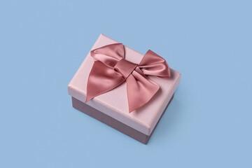 Gift box with a pink bow on a  blue  background