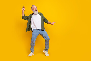 Full length body size photo of senior happy man in stylish clothes dancing party weekend isolated vivid yellow color background copyspace