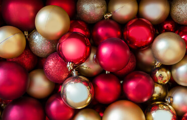 Full frame shot of Christmas ornaments, red and gold Christmas tree decorations.