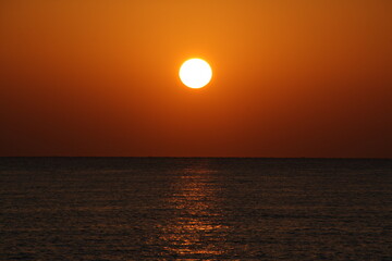 sun disc over blue sea