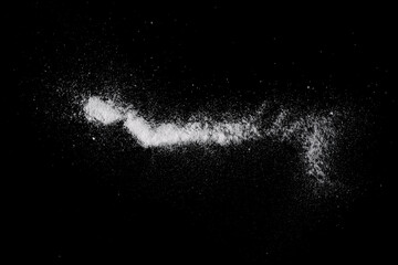 Fototapeta premium A handful of soda scattered on a black surface.