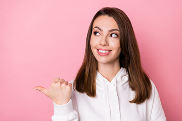 Photo of young girl happy positive smile look indicate thumb empty space promo decide choice isolated over pink color background