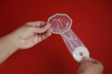 salvador, bahia, brazil - december 6, 2021: Woman holding female condom in Salvador city.