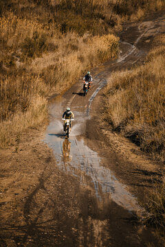Male bikers with on wet road during enduro motorcycle racing