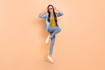 Fototapeta na wymiar Full size photo of smiling pretty businesswoman carefree jumping free time relaxing isolated on beige color background