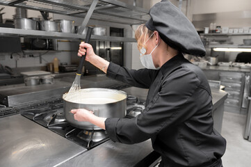 Portrait of a female chef cooking at commercial kitchen. High quality photo