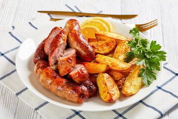 fried sausages on a plate with potatoes