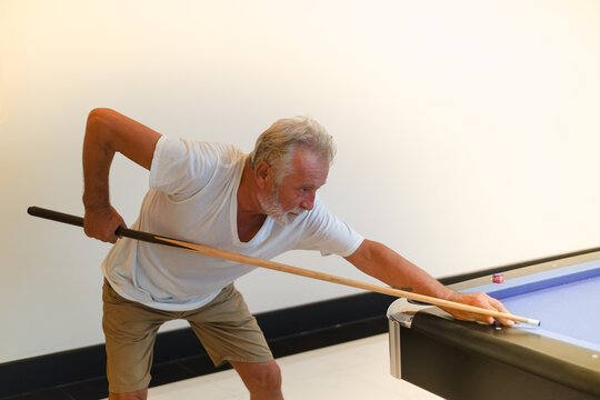 Portrait Caucasian Older, Senior Man Playing Billiards On Pool Table