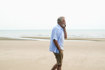 portrait caucasian old man relaxing on sea beach