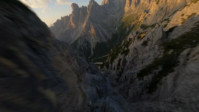 FPV drone aerial view of Tre Cime di Lavaredo with clouds, Dolomiti di Sesto, South Tirol, Dolomiten mountains view, Italian Alps