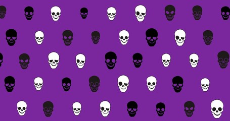 Digitally generated image of spooky skulls against purple background with copy space