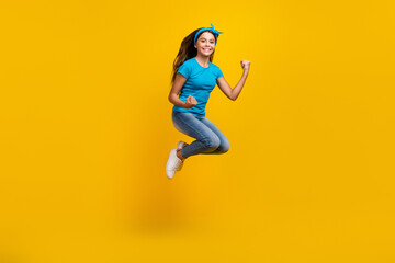 Fototapeta na wymiar Full body profile side photo of young excited girl jump rejoice victory fists hands awesome isolated over yellow color background