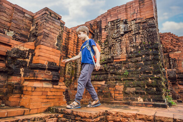 Boy tourist in Temple ruin of the My Son complex, Vietnam. Vietnam opens to tourists again after quarantine Coronovirus COVID 19