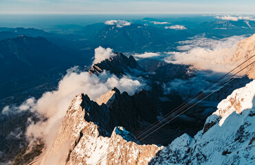 Beautiful alpine summer evening view with dramatic clouds at the famous Zugspitze summit, top of...