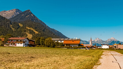 Beautiful alpine summer view with a church and the alps near Reutte in the background at Bichlbach, Tyrol, Austria